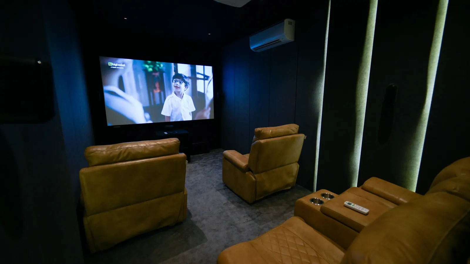 Media room with recliners facing a large screen